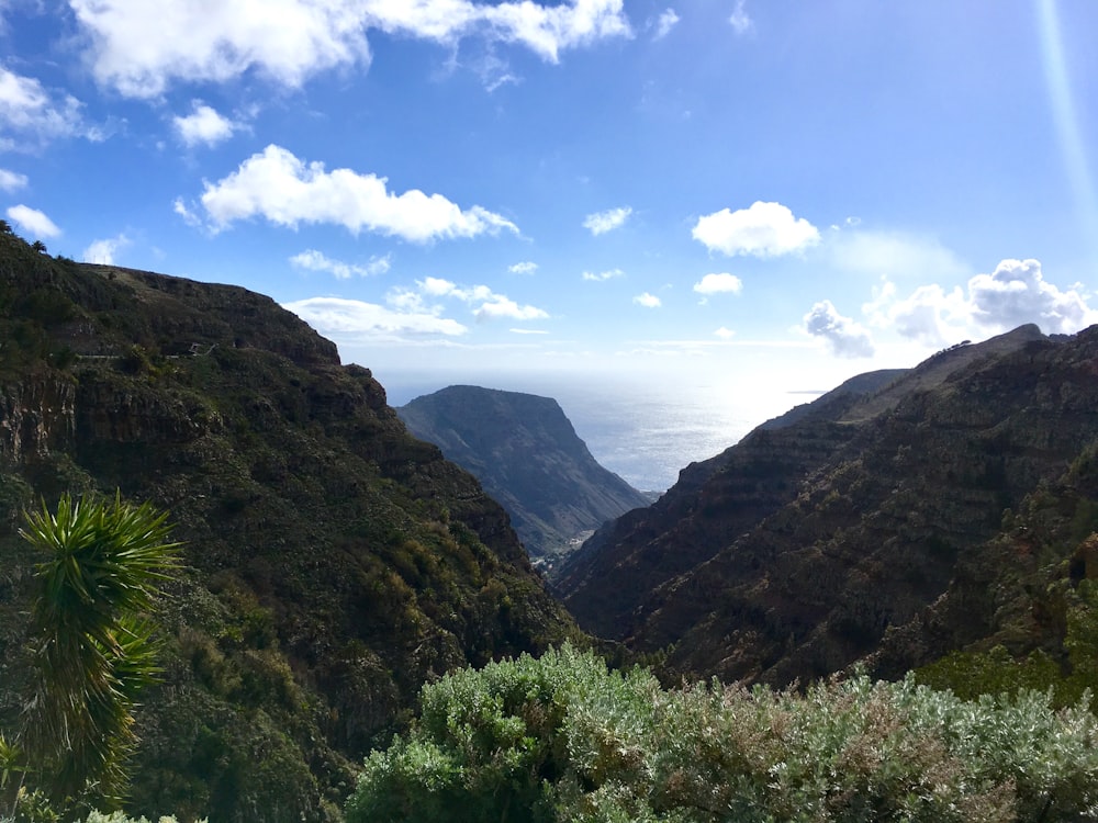 a view of a valley with mountains in the background