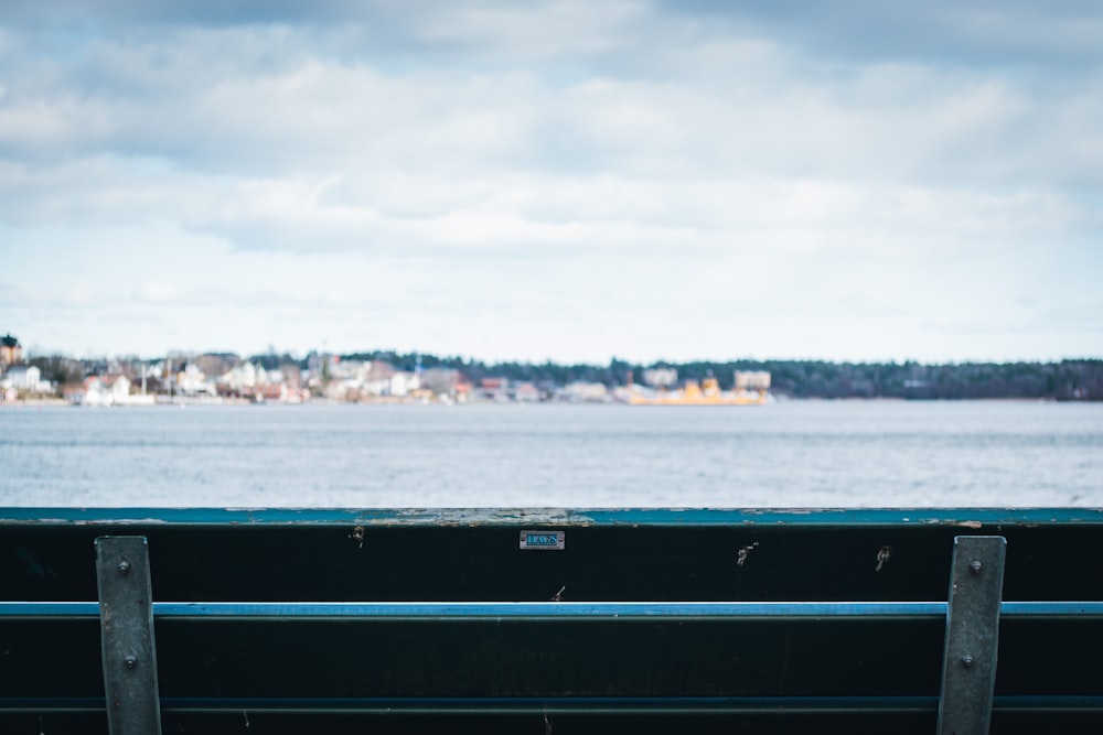 a bench sitting in front of a body of water