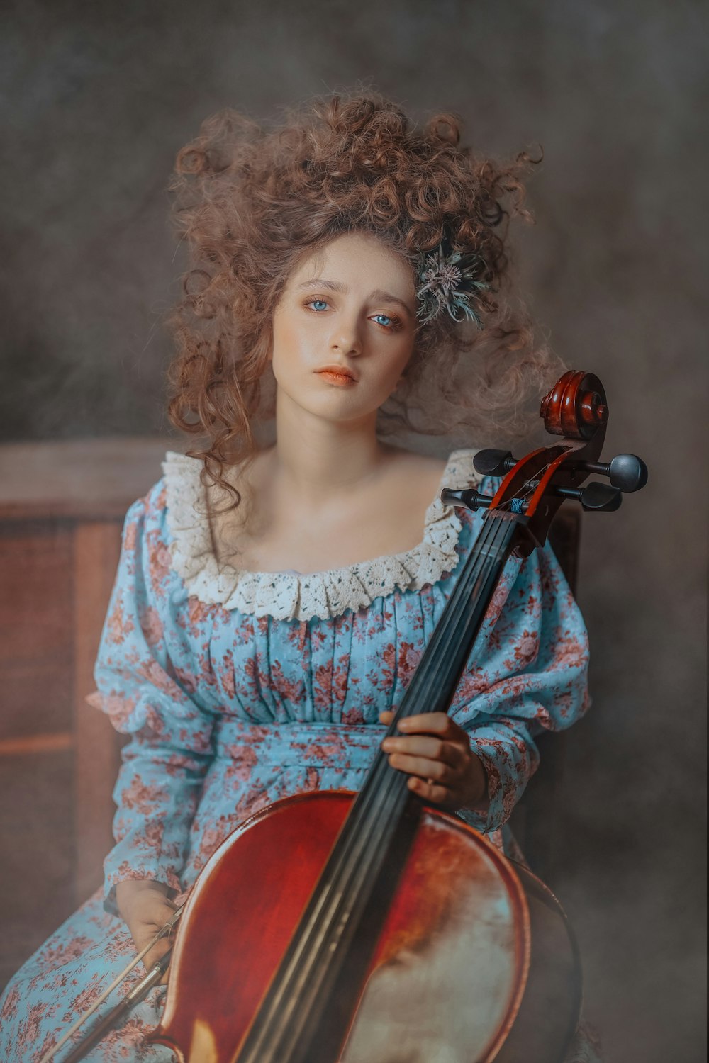 a doll with curly hair holding a violin