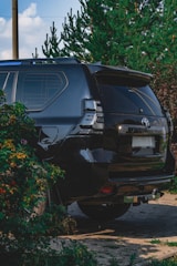 Wide shot of an SUV with professionally tinted windows parked outdoors on a clear day.