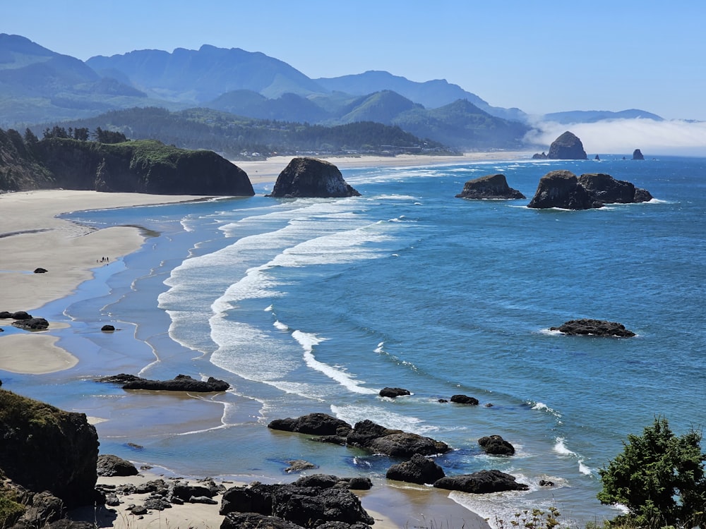 a view of a beach with mountains in the background