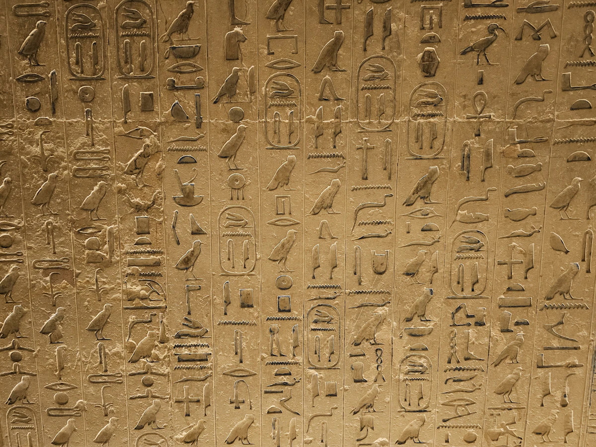 Golden Egyptian hieroglyphs on a wall