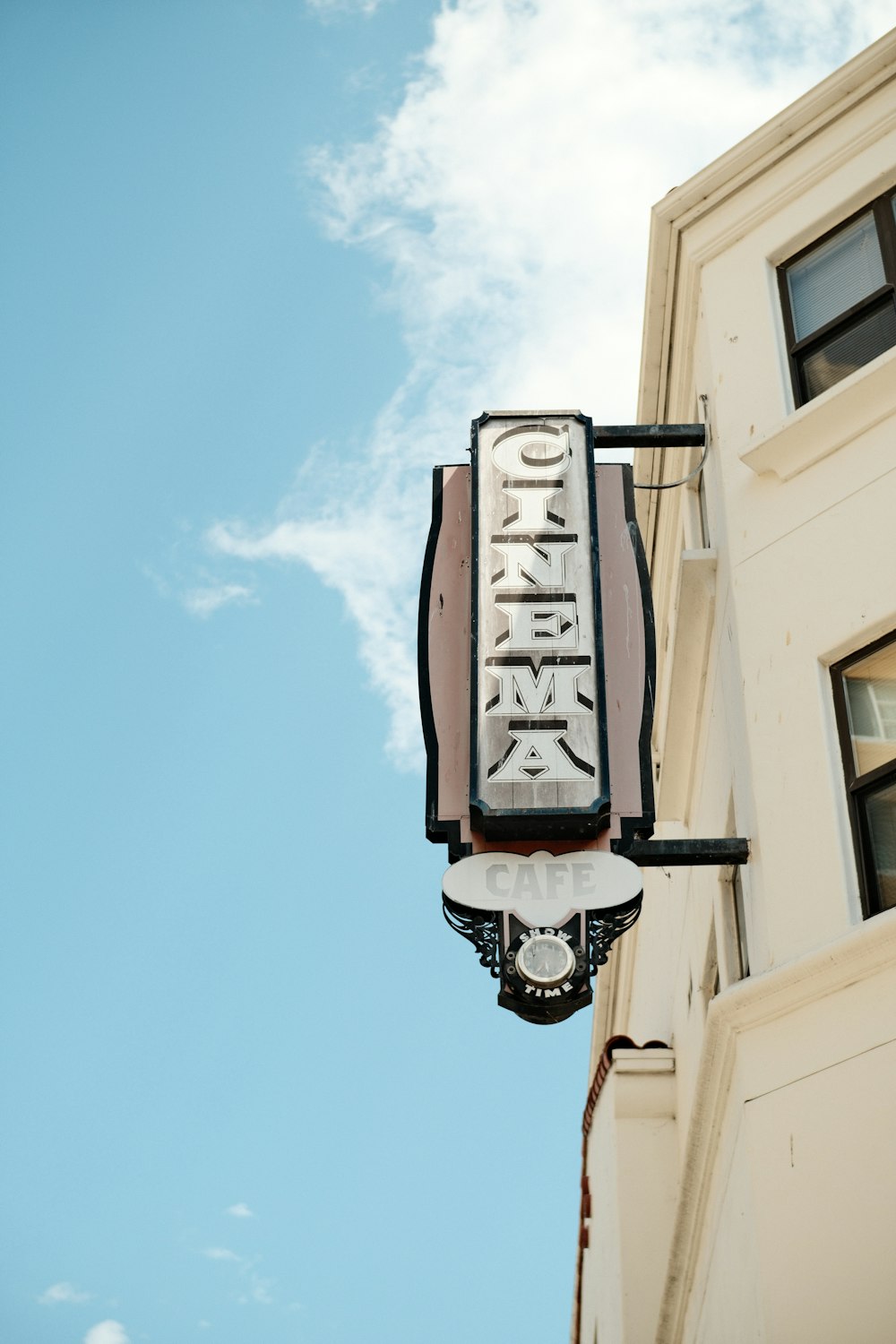 a building with a sign hanging off the side of it