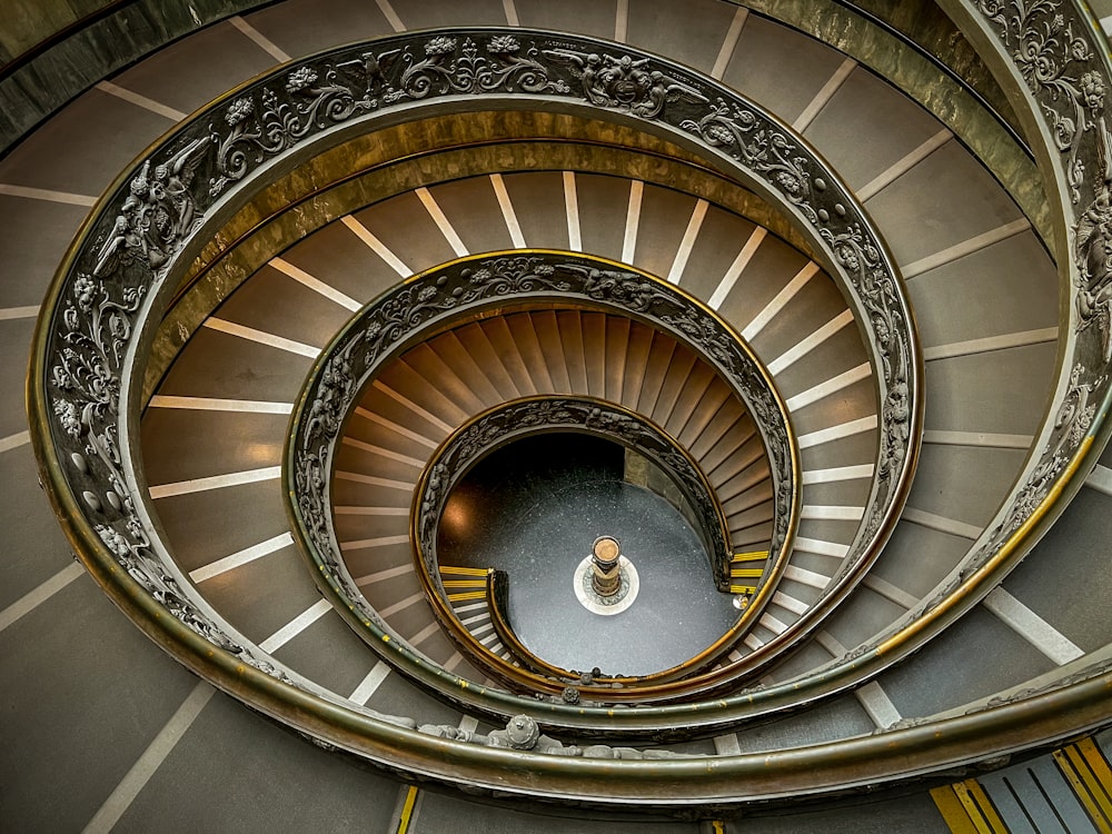 a spiral staircase in a building with metal railings