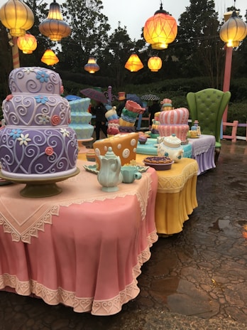 A whimsical tea party setup with unique teacups and teapots.
