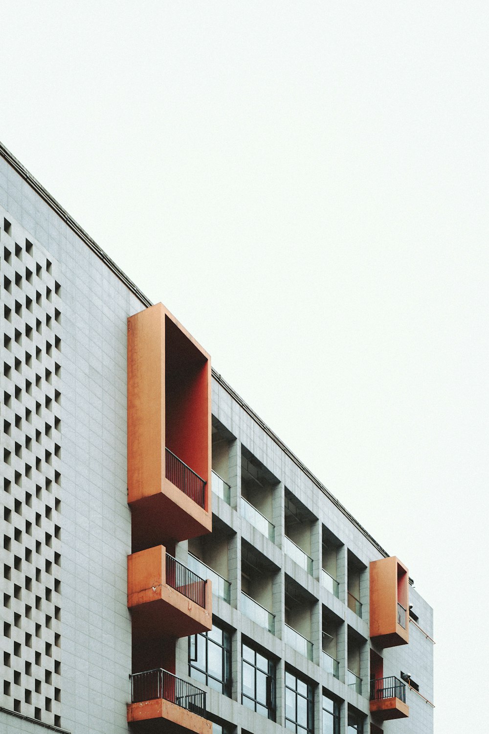 an orange and white building with balconies and balconies