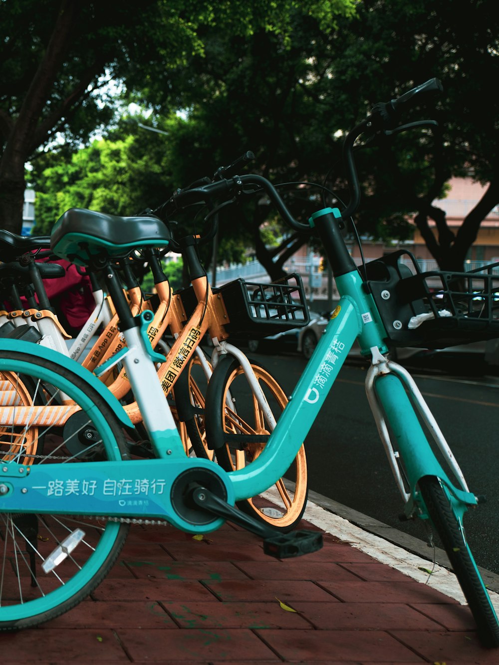 a group of bikes parked next to each other on a sidewalk