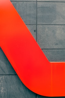 A vibrant kitchen backsplash painted in bold red, highlighting clean edges and attention to detail.