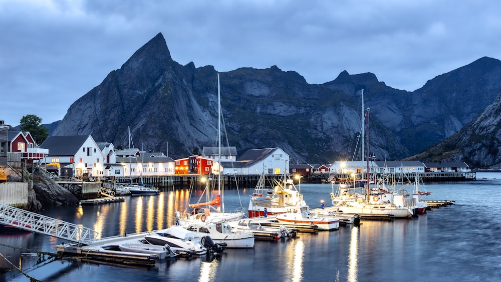 a harbor filled with lots of boats next to mountains