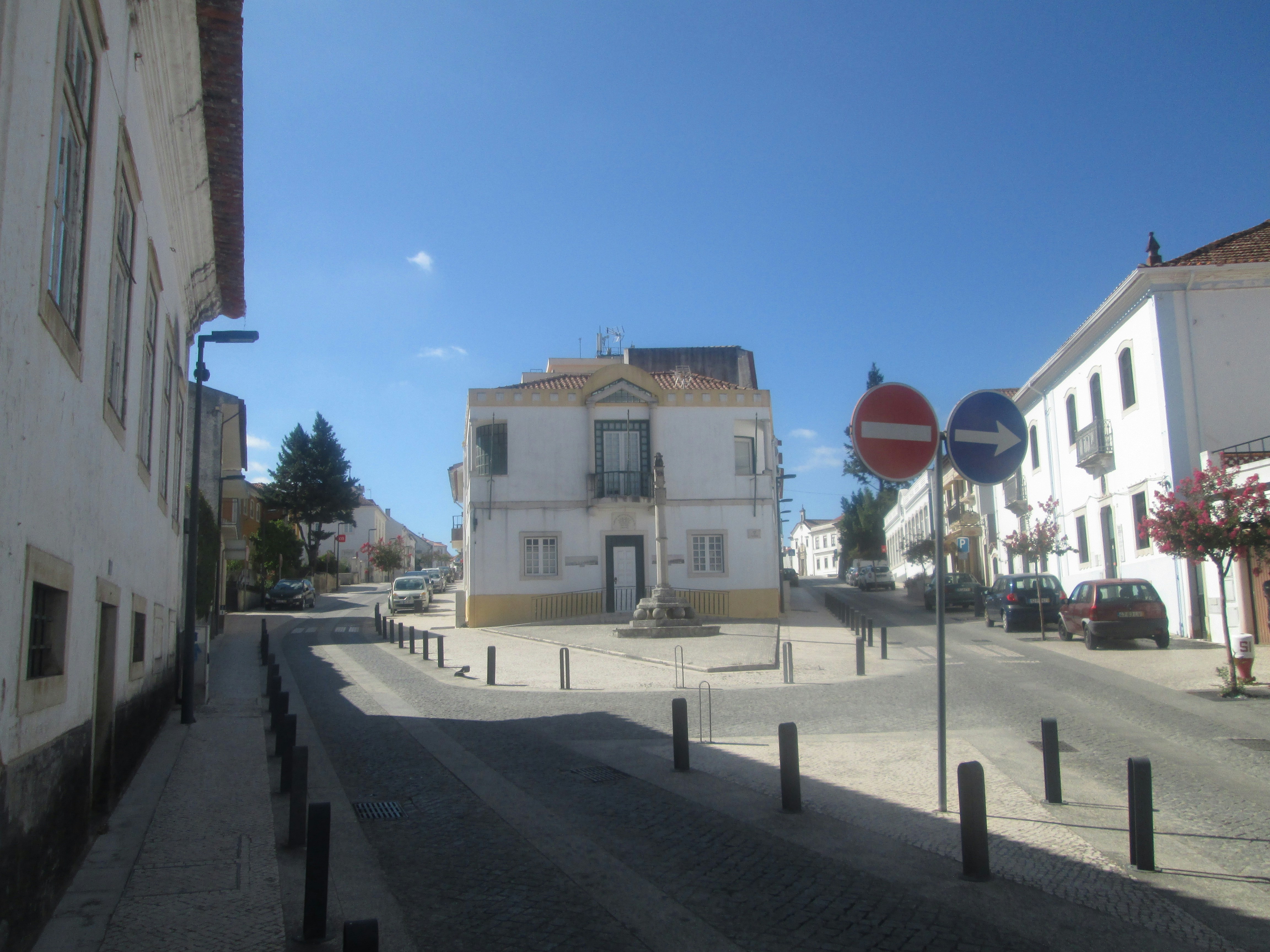 a street with a building and a street sign