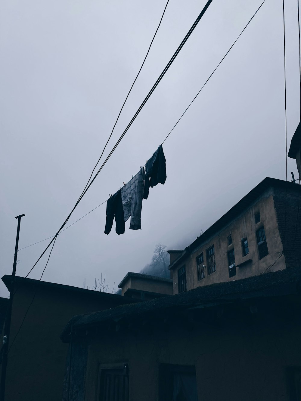 clothes hanging on a clothes line in front of a building