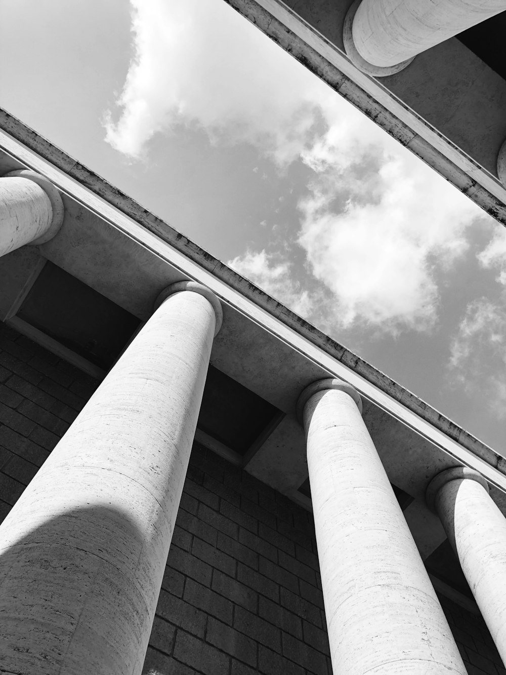 a black and white photo of three pillars