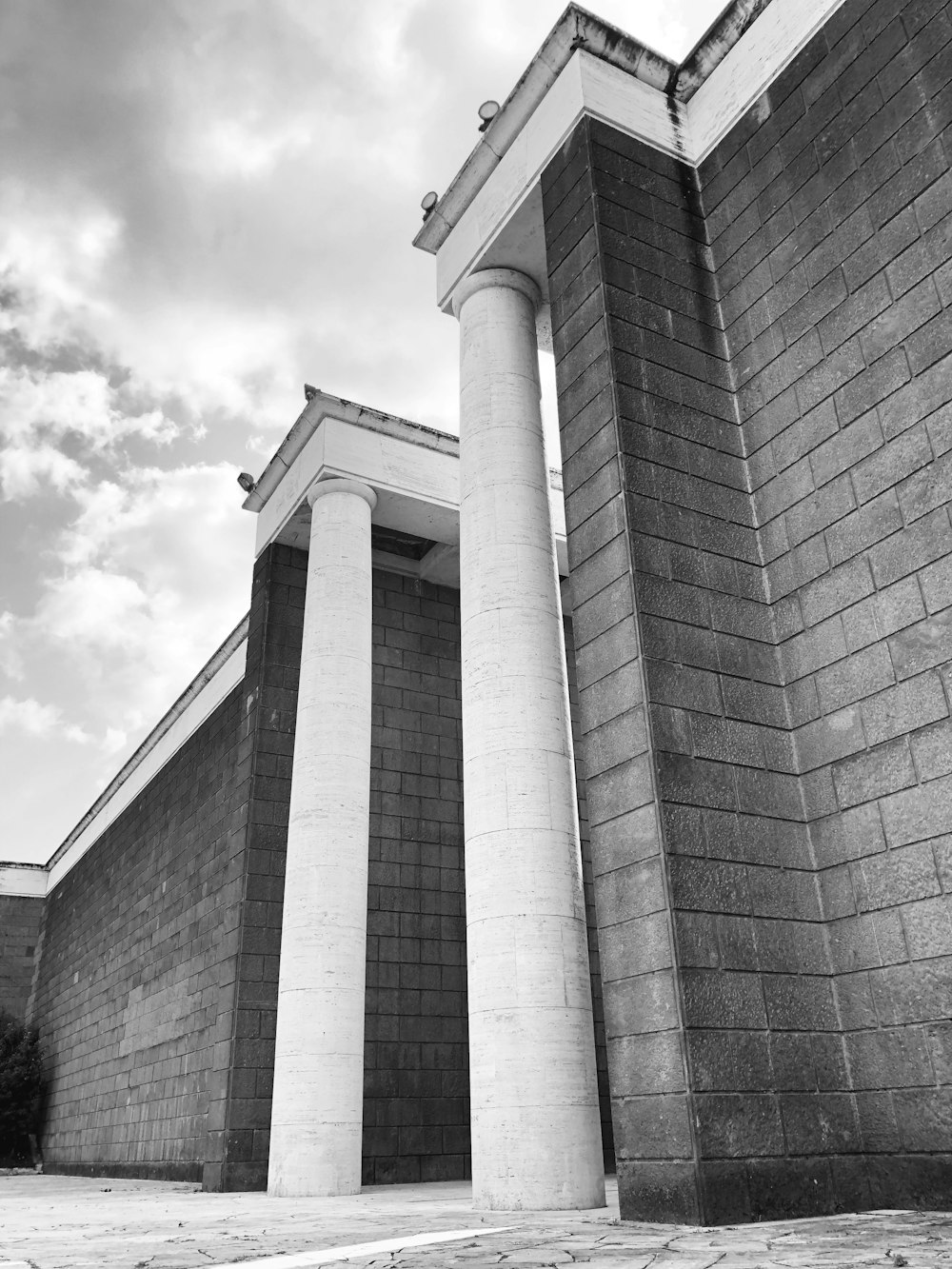 a black and white photo of two tall pillars