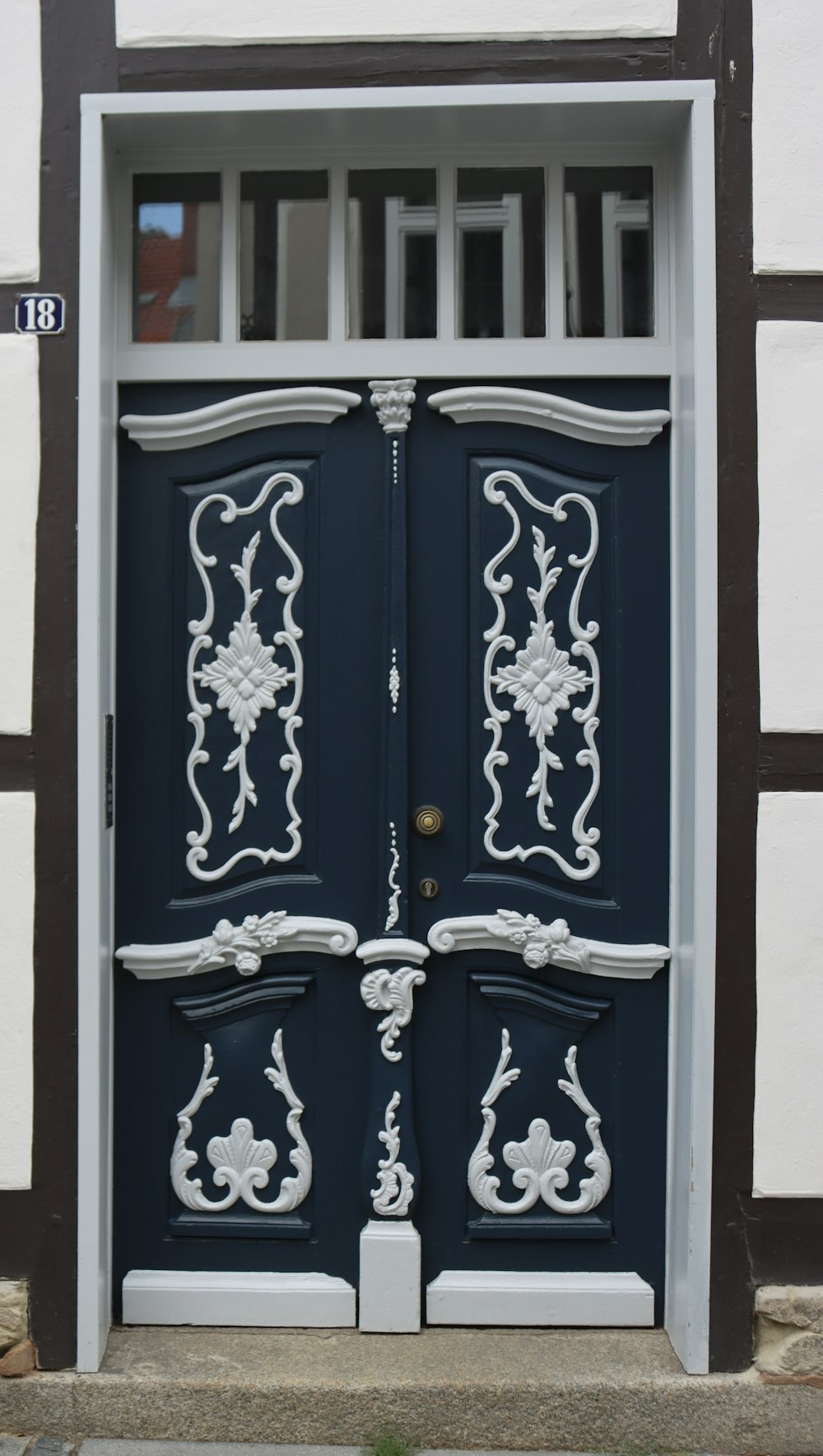 a black and white door with ornate designs