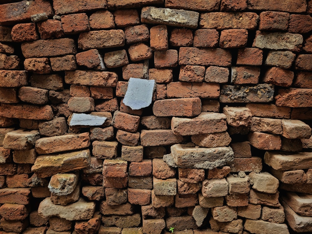 a pile of bricks with a piece of paper stuck to it