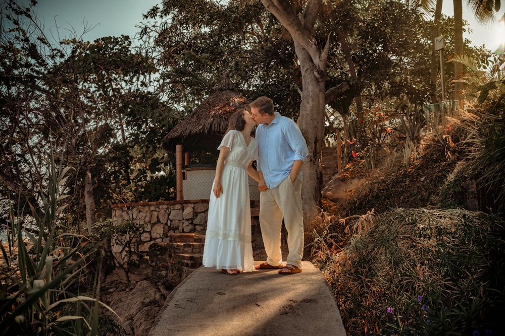 a man and a woman are standing on a dock