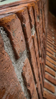 a close up of a brick wall with a clock on it