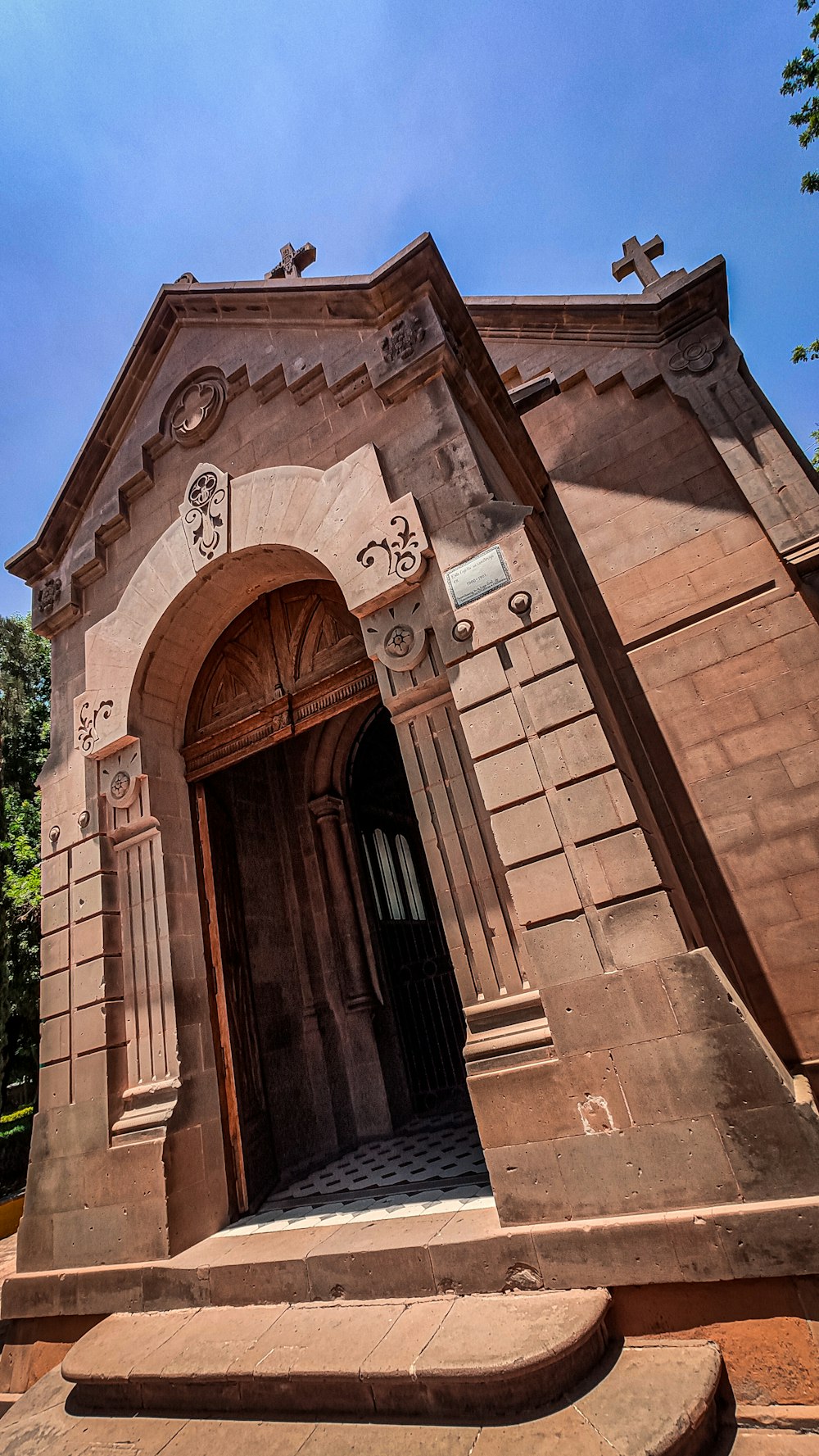 an old church with a cross above the door