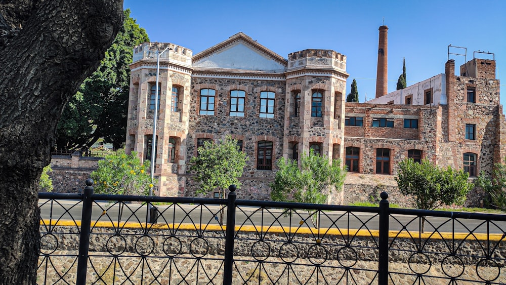 a large brick building sitting next to a tree