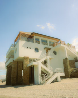 Modern coastal house under construction with protective materials against sea corrosion.