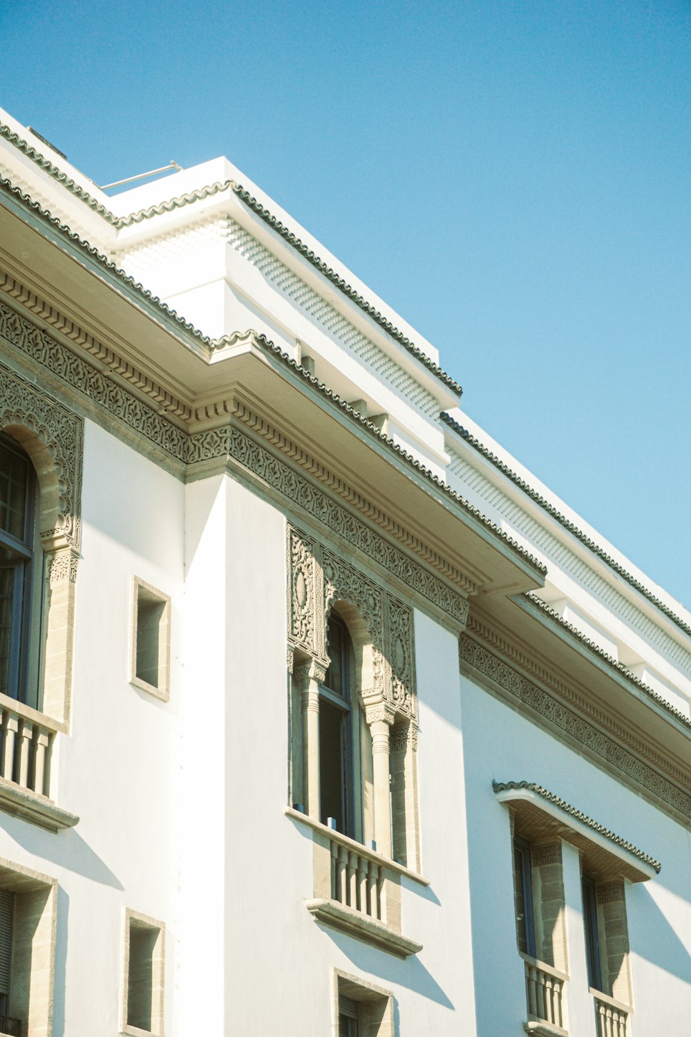 a white building with a clock on the front of it