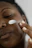Close-up of hands applying a luxurious cream on smooth skin.