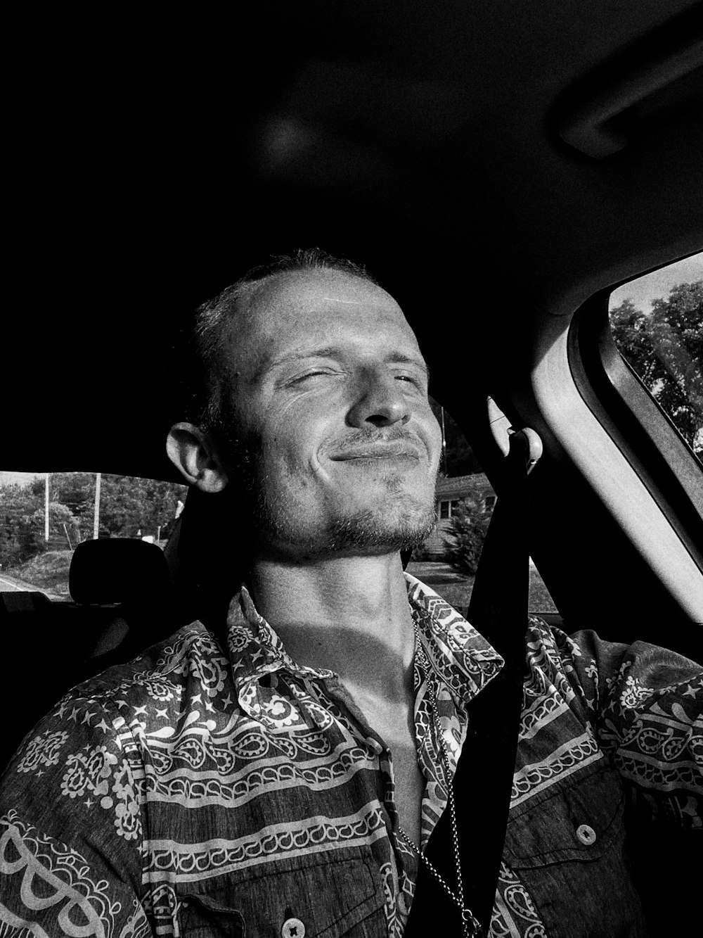 a man sitting in the back seat of a car