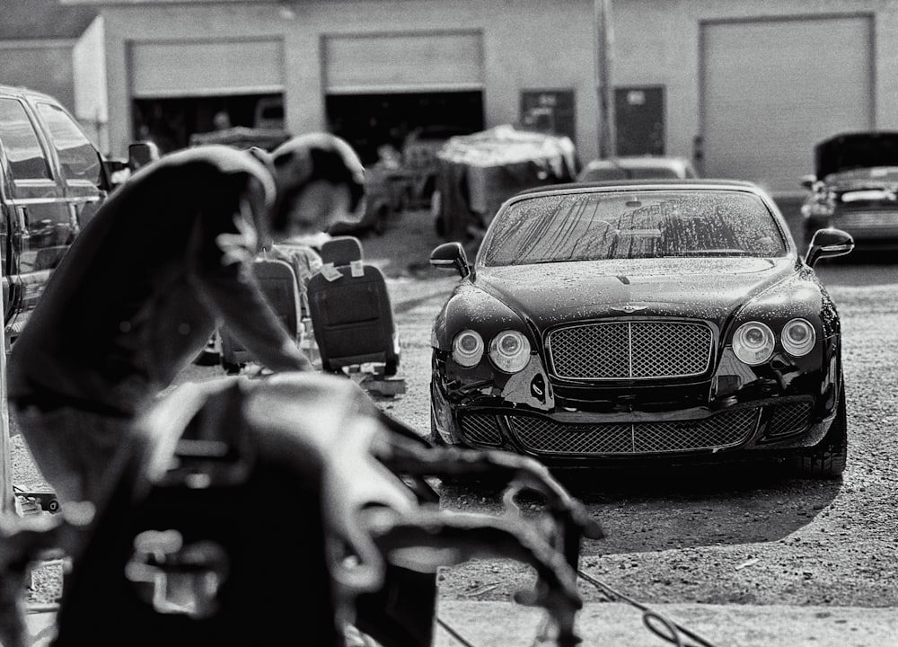 a black and white photo of a car in a parking lot