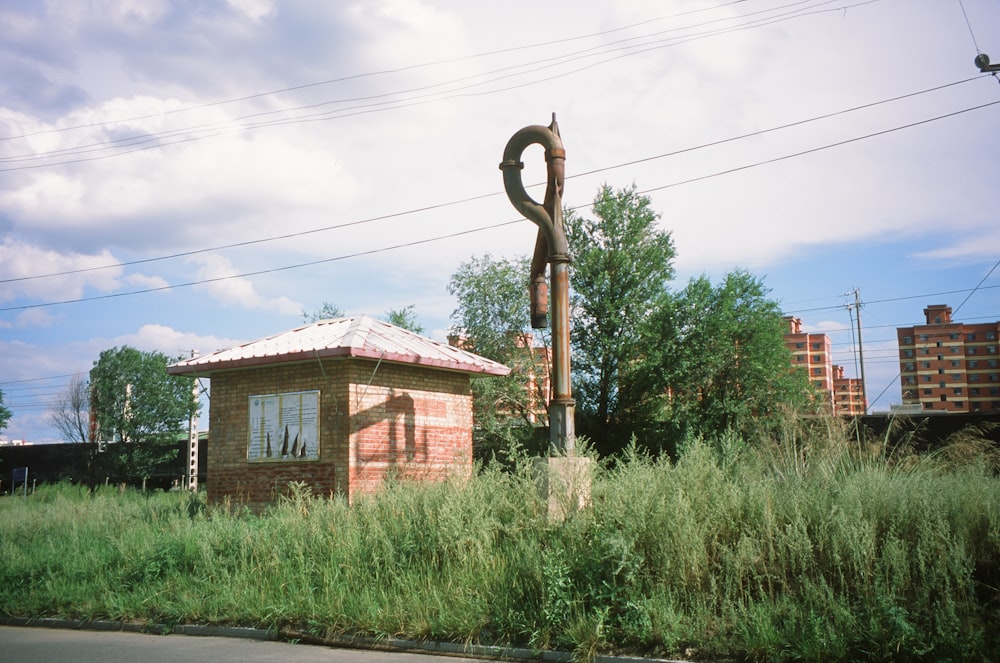 a brick building with a sculpture in front of it