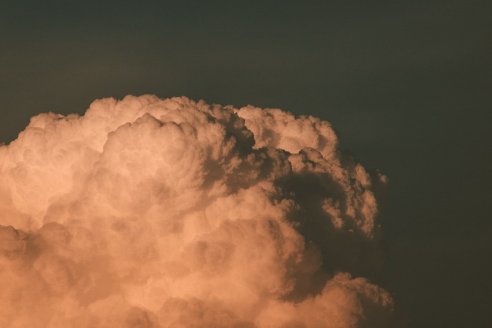 a plane flying in the sky with a lot of clouds