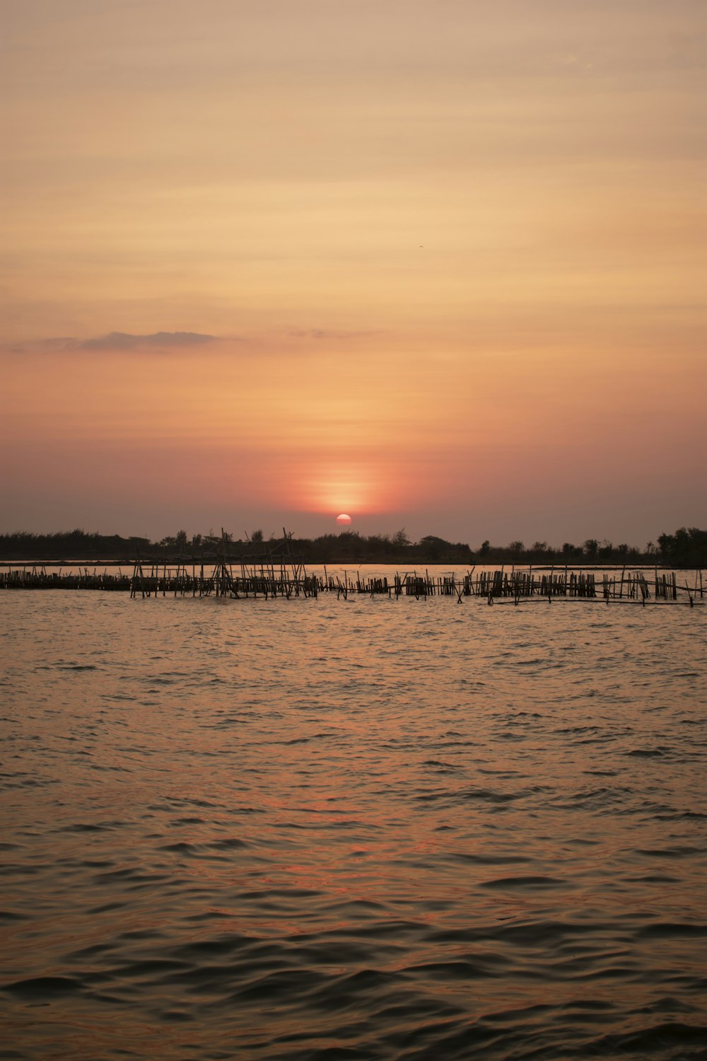 the sun is setting over a body of water