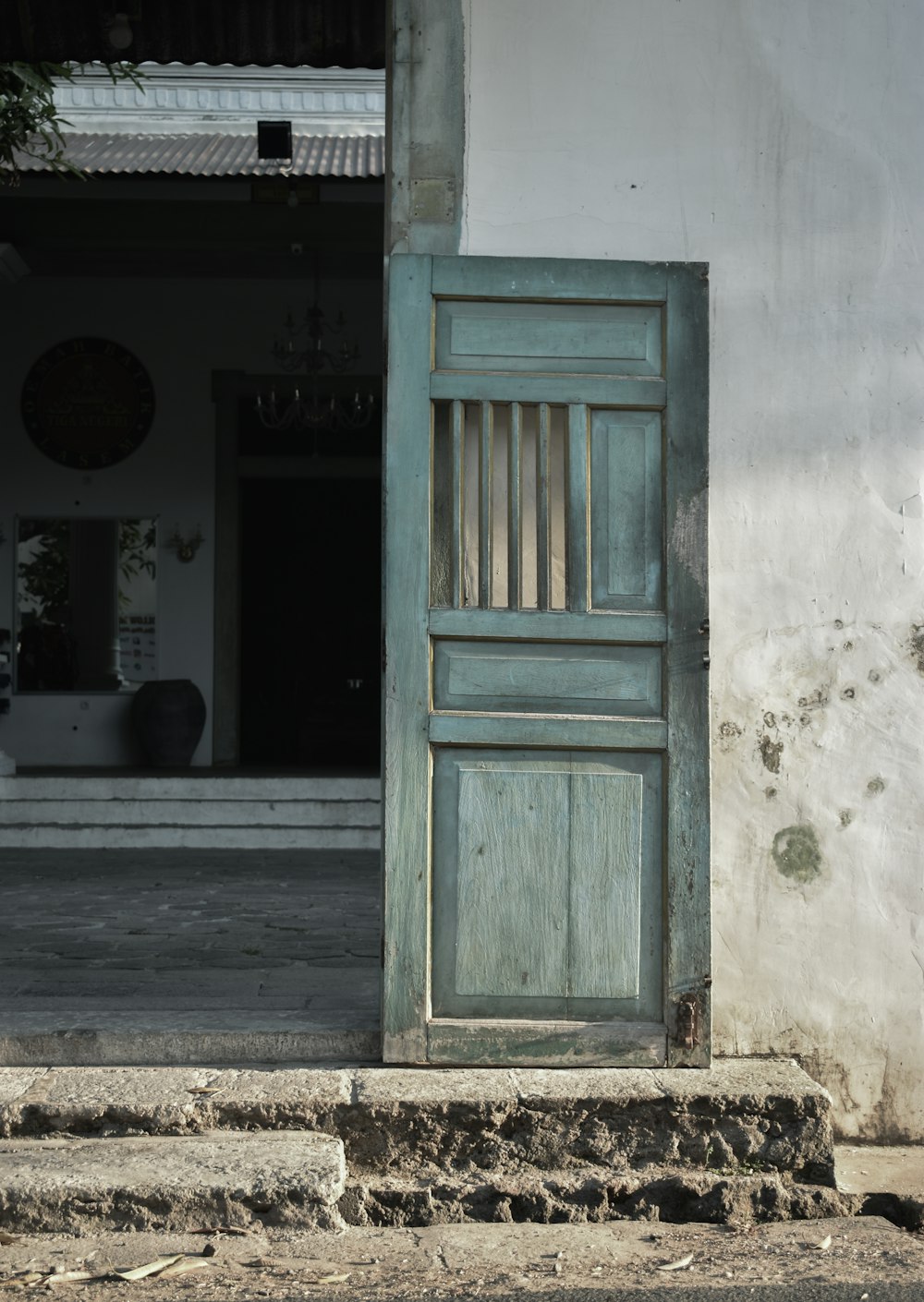 an old door is open on the side of a building