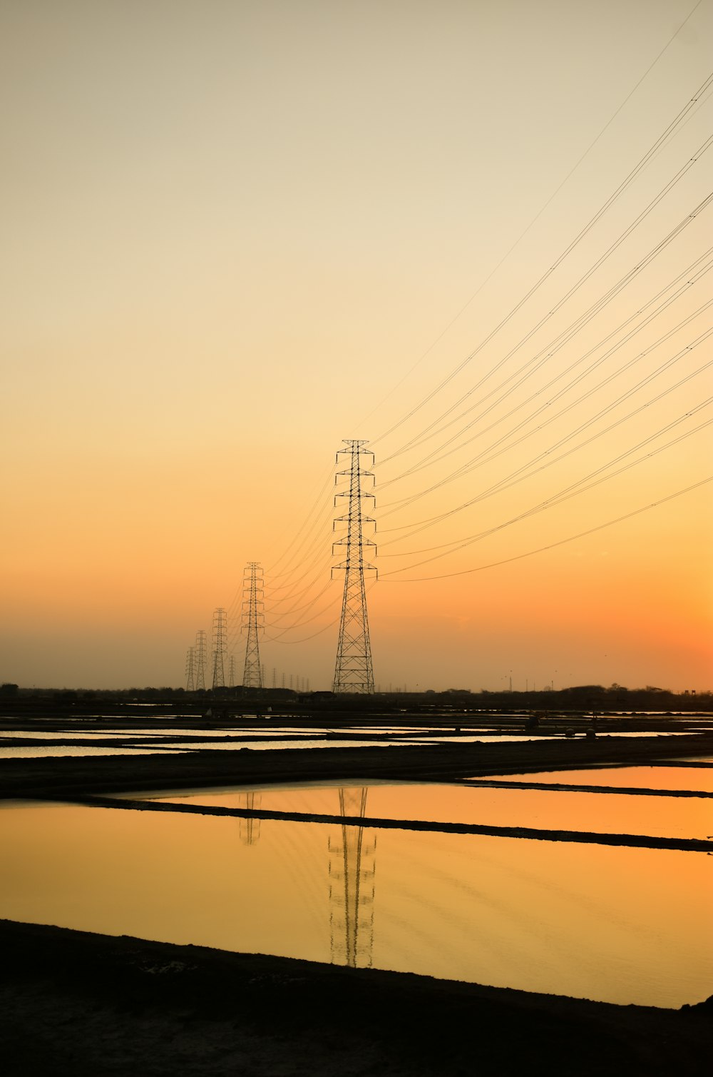 a large body of water with power lines in the background