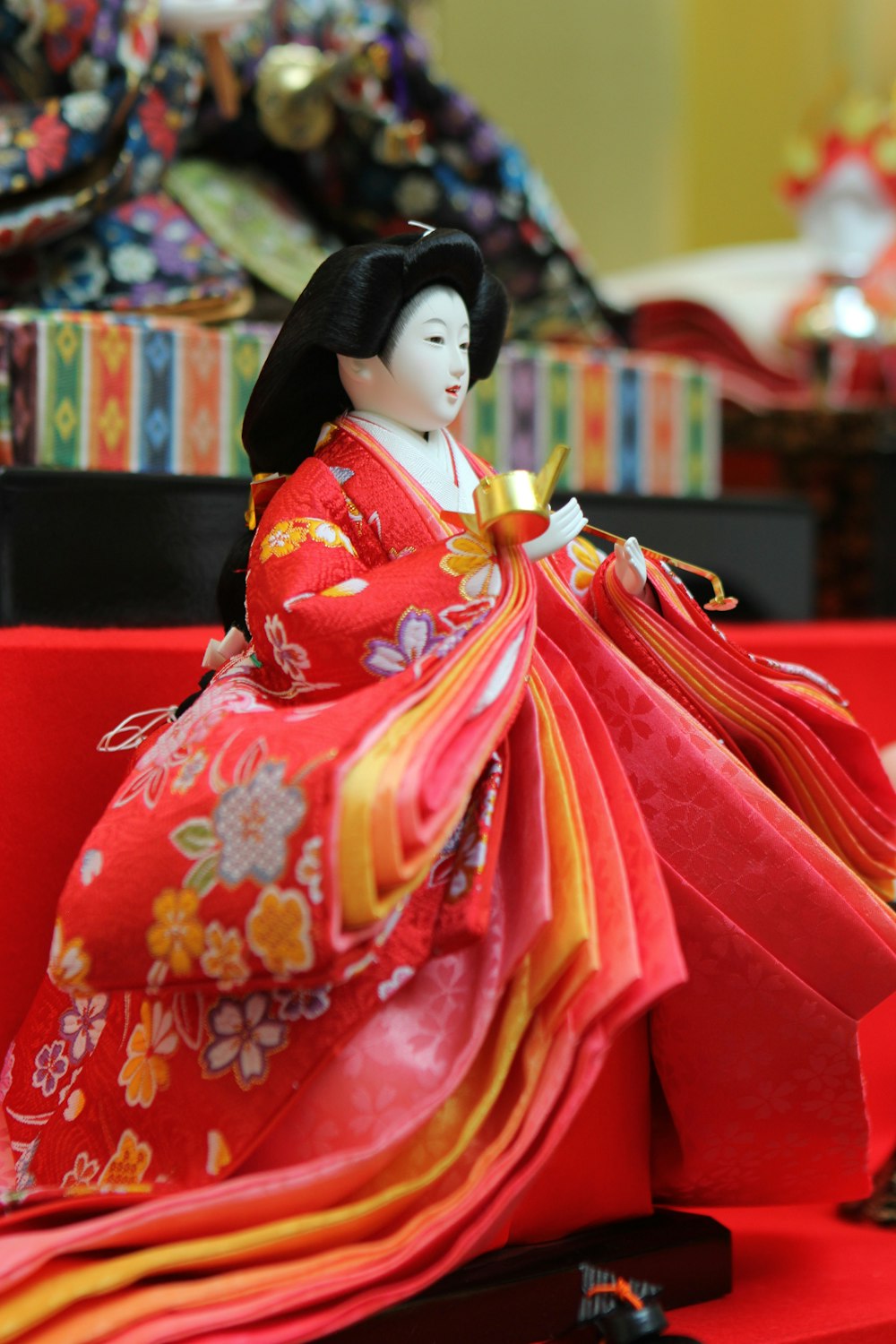 a figurine of a woman in a red kimono