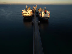 two large ships in the middle of a body of water