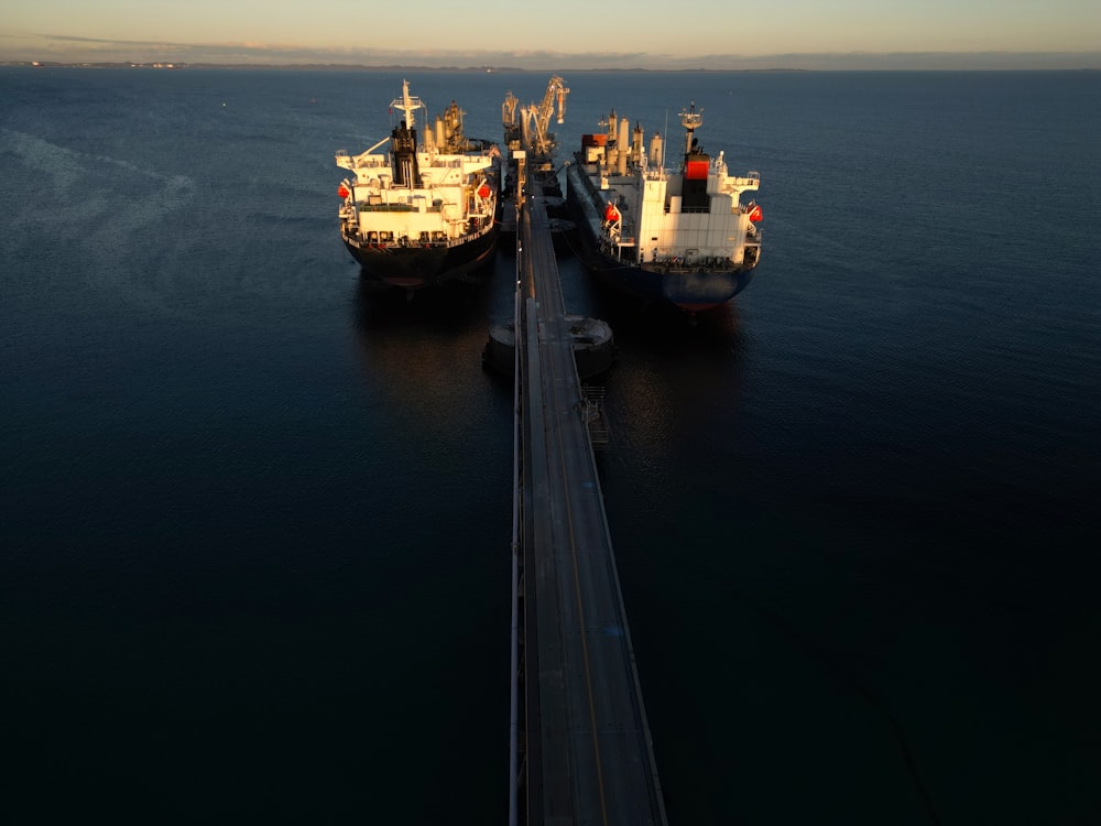 two large ships in the middle of a body of water