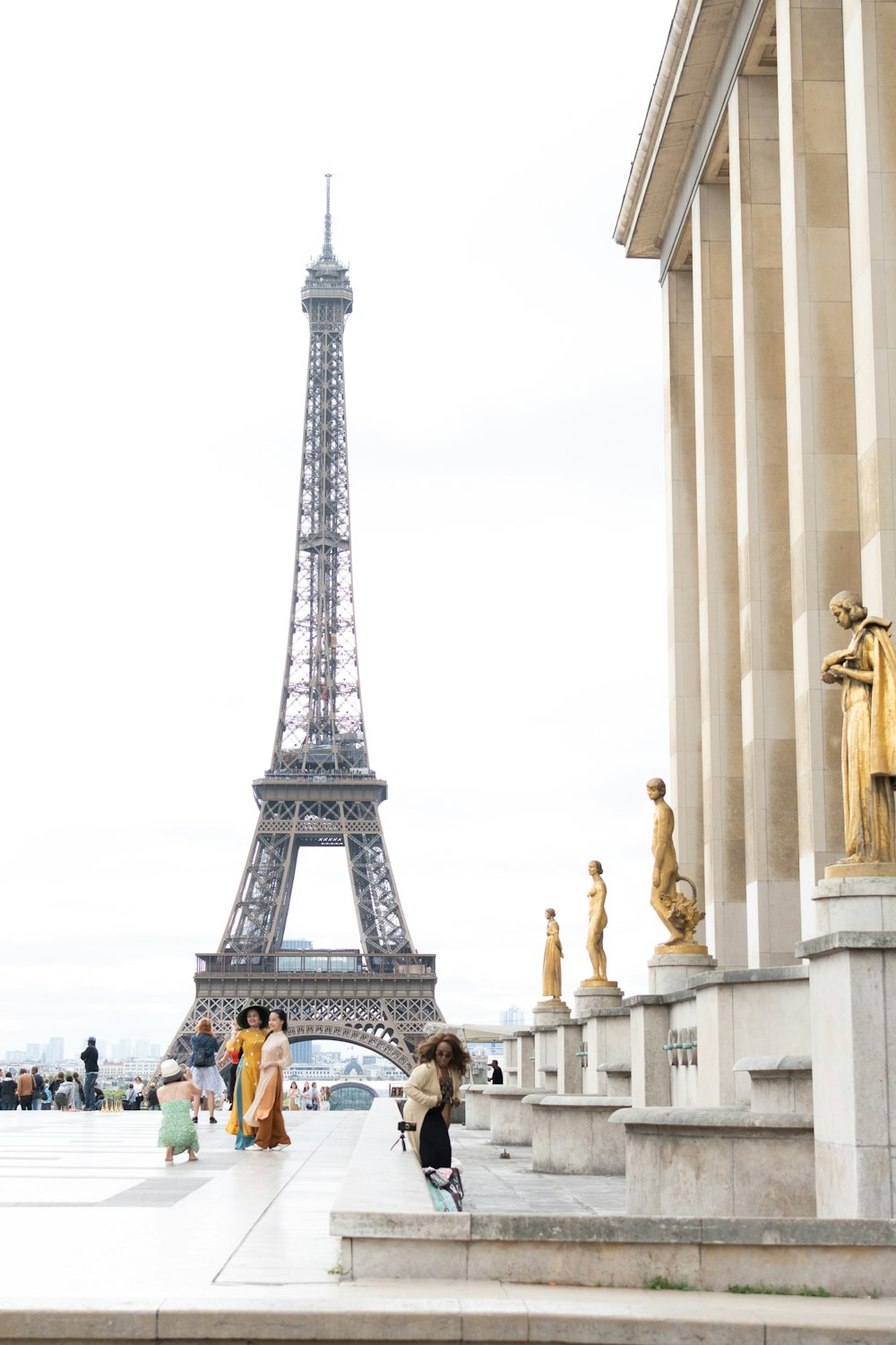 a group of people standing in front of the eiffel tower