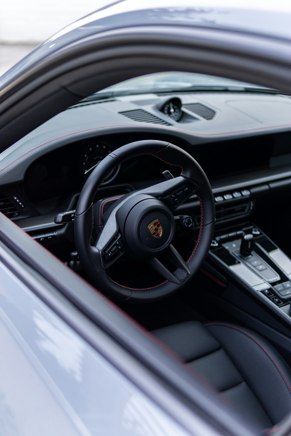 a close up of a car's steering wheel and dashboard