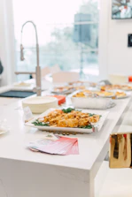 A variety of air fryer models displayed side by side in a bright kitchen.
