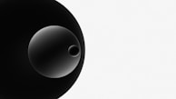 A minimalistic composition featuring a large black circle overlapping with a smaller gradient circle and an even smaller circle inside it, all set against a white background.