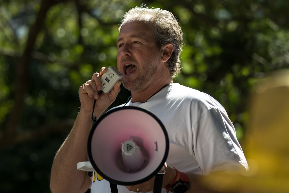 a man holding a megaphone up to his ear