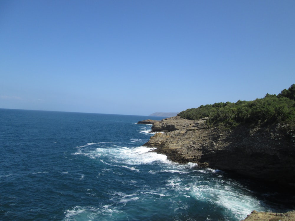 a rocky cliff overlooks a body of water