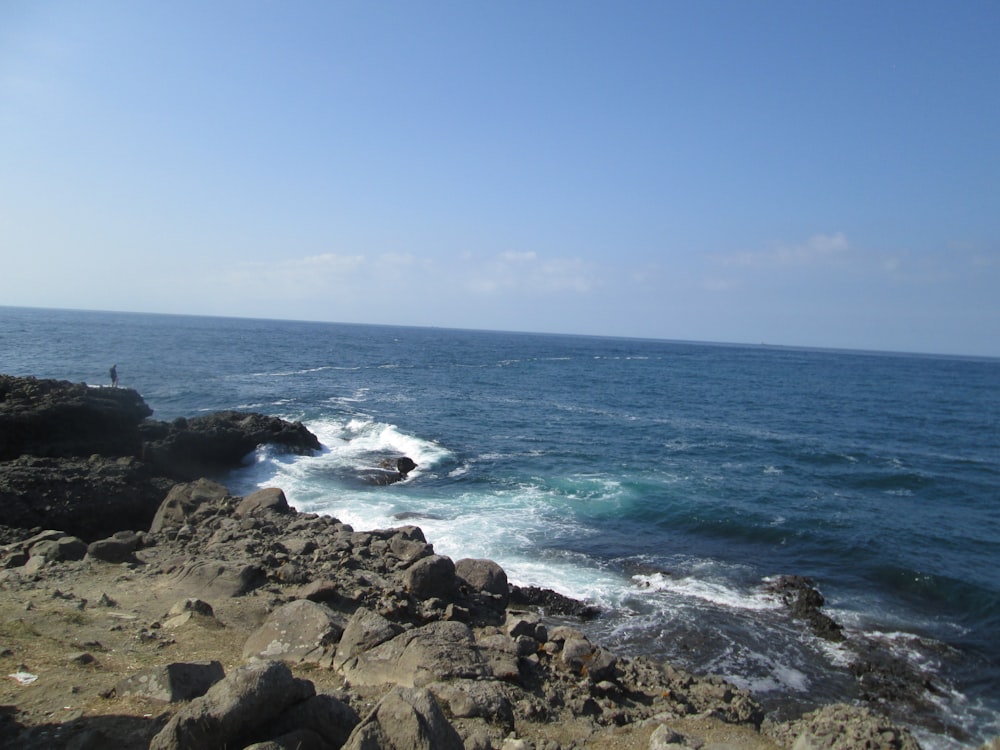 a view of the ocean from a rocky cliff