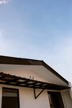 Before and after shots of a house showing an old roof being replaced with a fresh, modern roof.