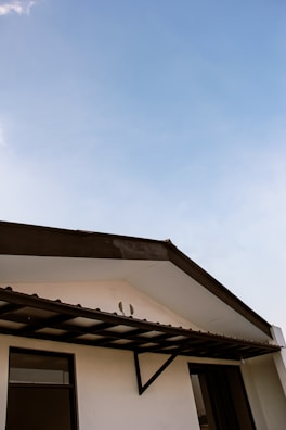 Before and after side-by-side view of a complete roof replacement on a residential house.