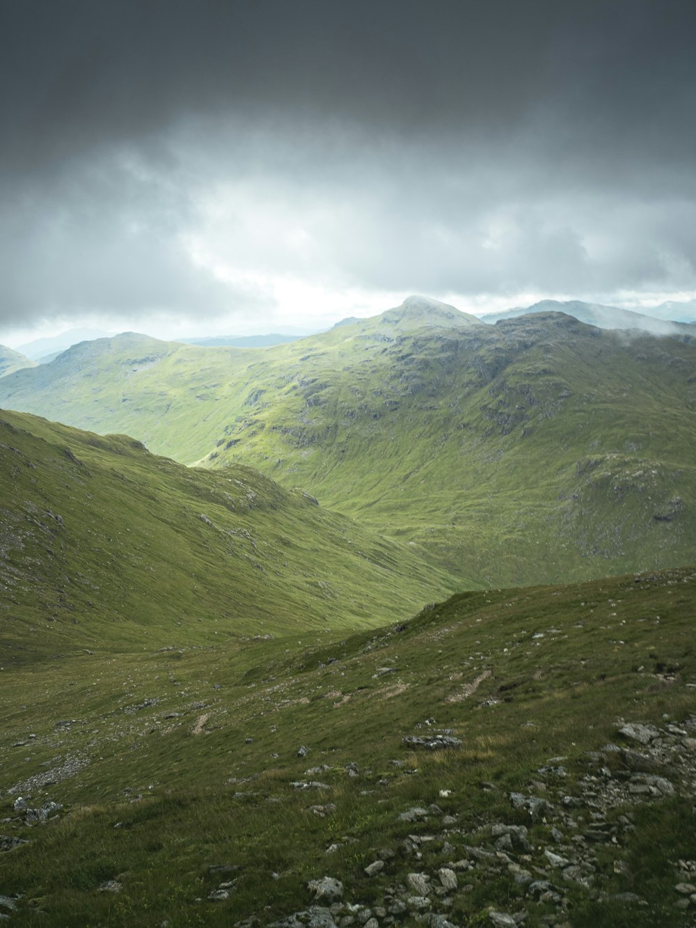 a view of a mountain range from the top of a hill