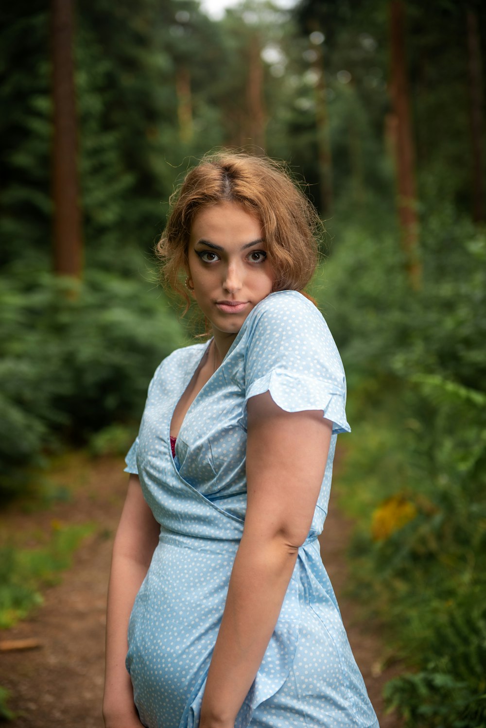 a woman in a blue dress posing for a picture