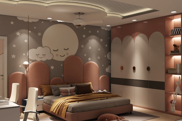 A cozy bedroom with a playful design featuring a wall mural of a smiling moon and clouds surrounded by stars. The room is furnished with a modern bed adorned with brown and gold pillows, a matching blanket, and a cushioned headboard. To one side of the room, there are two beige chairs placed against a white desk, and to the other, a wardrobe with arch-shaped patterns. Soft lighting adds to the warm ambiance.