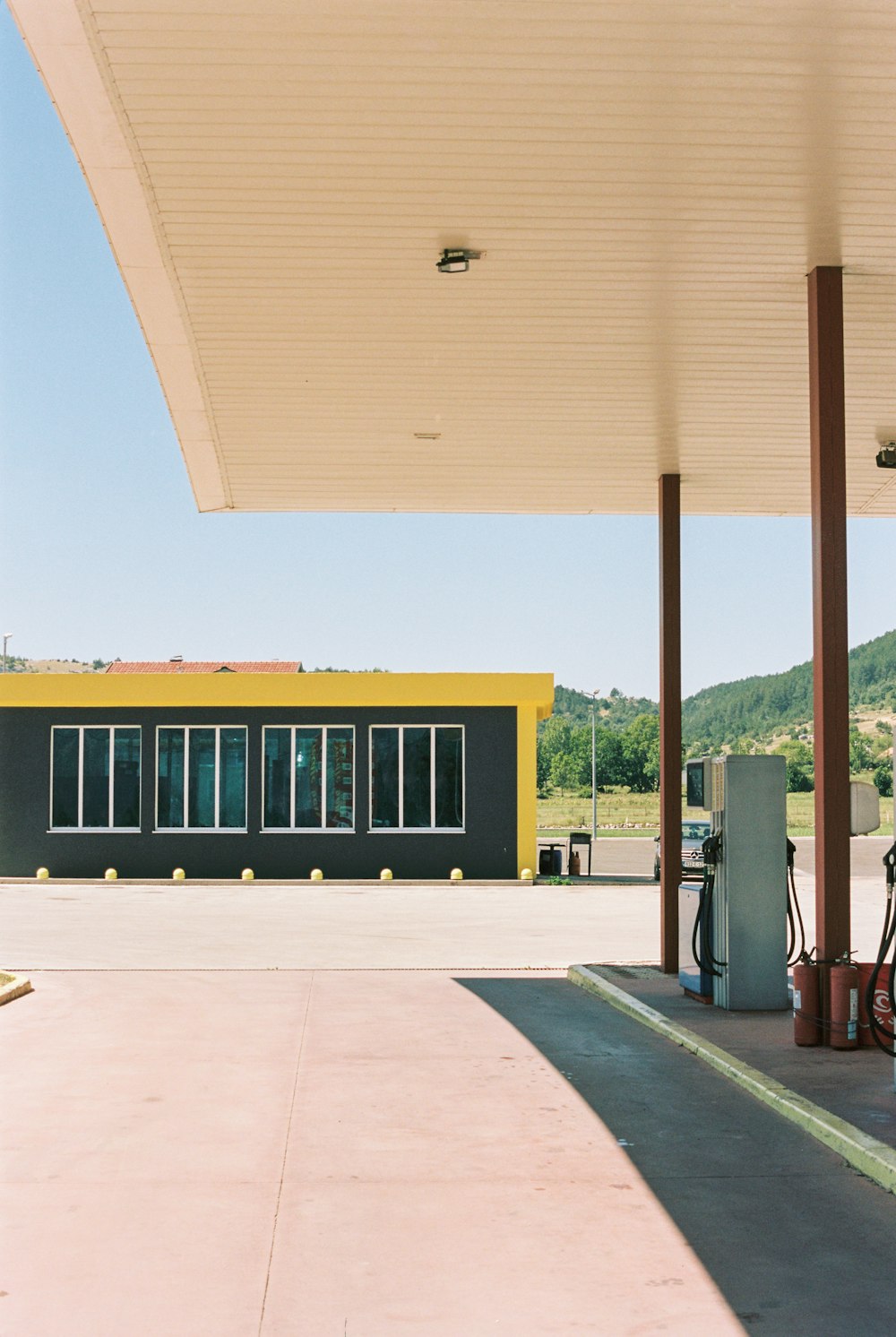 a gas station with a yellow and black building