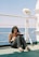 a woman sitting on a boat reading a book